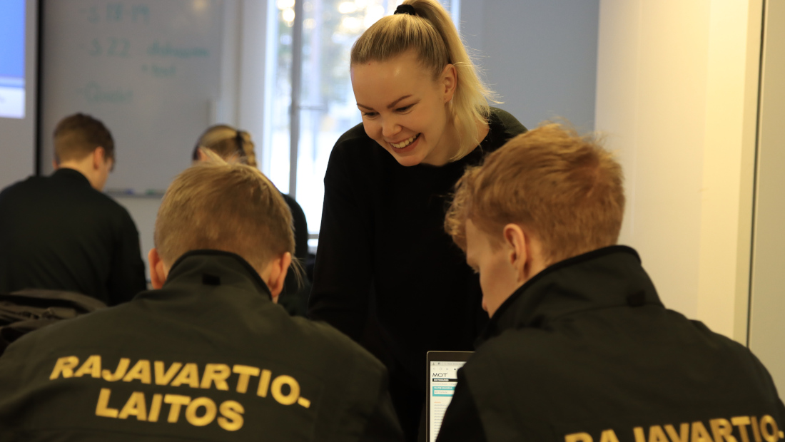 Border guard students and their teacher in the classroom.