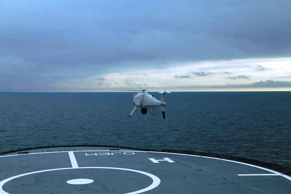 An unmanned aircraft (drone) has taken off from the ship’s deck.