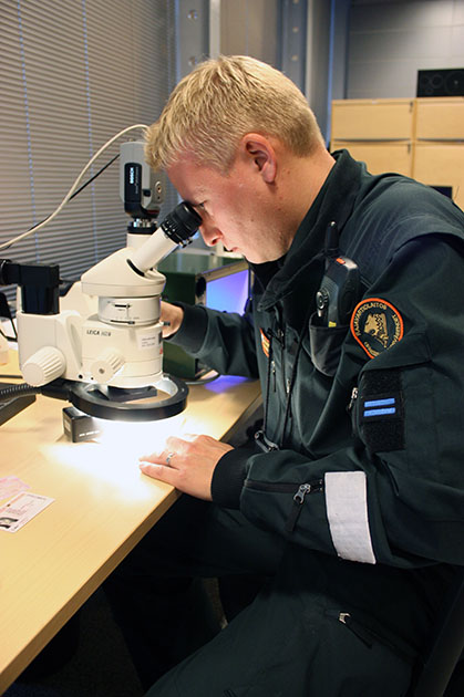 En sjöbevakare undersöker ett resedokument.