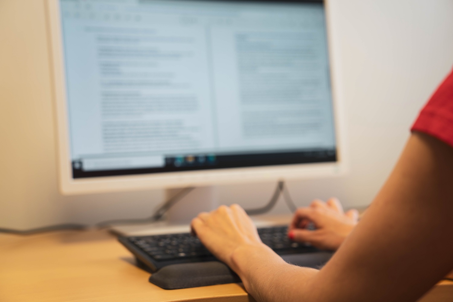 A person writes on a computer.