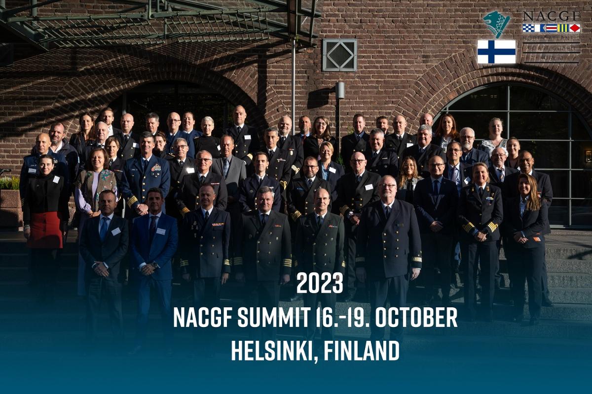 A group photo taken in front of a brick wall.