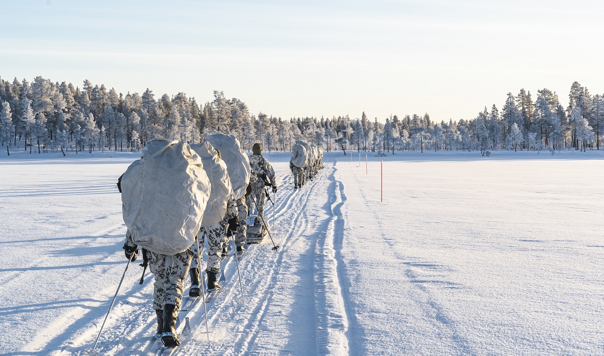 Rajajääkärikomppanian varusmiehet hiihtävät Lapissa lumisessa maisemassa