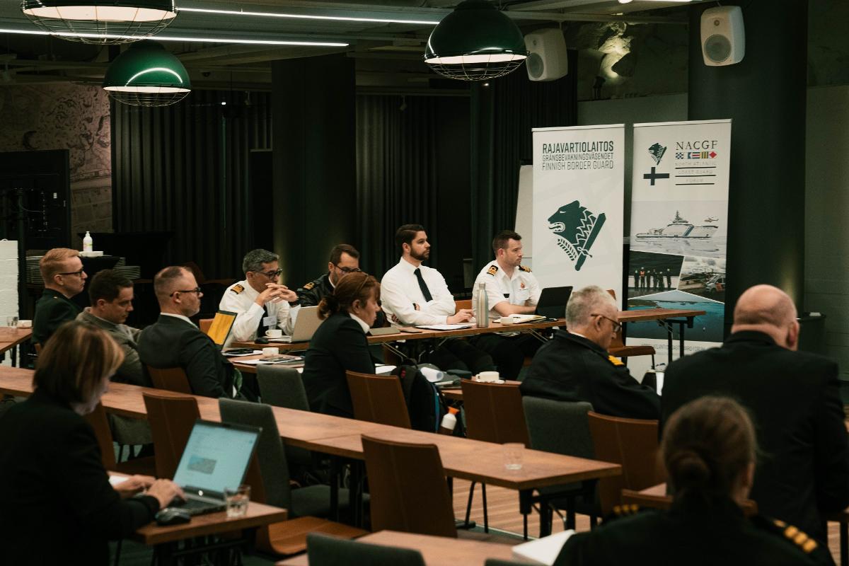 People in a conference room listening to a presentation.